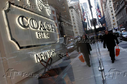 FILE PHOTO: People walk past a Coach store on Madison Avenue in New York