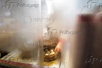 A woman prepares Xiaolongbao, or 