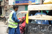 Volunteers distribute cold drinks on a roadside in Hyderabad