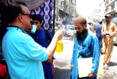 Volunteers distribute cold drinks on a roadside in Hyderabad