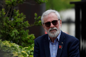 Former Sinn Fein President Gerry Adams sits outside the High Court, in Dublin