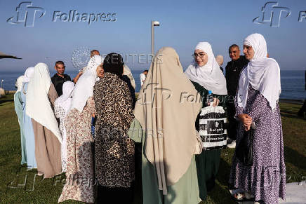 Israeli Muslims pray on the first day of the Muslim holiday of Eid al-Adha by the sea side of the Mediterranean, in Jaffa