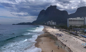 People attend a symbolic ritual named 'O Abraco' marking the World Oceans Day, at Sao Conrado beach in Rio de Janeiro