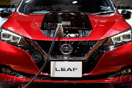 FILE PHOTO: A charging cable is attached to a Nissan Leaf electric car at the 2019 Tokyo Motor Show