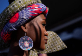 A model prepares to take part in a fashion competition during the Durban July horse race in Durban