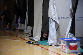 People evacuated from villages, damaged by torrential rain, rest at a temporary shelter, in Yesan,