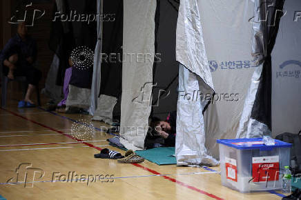 People evacuated from villages, damaged by torrential rain, rest at a temporary shelter, in Yesan,