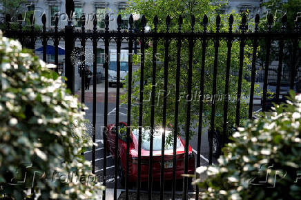A Tesla vehicle is parked in West Executive Avenue, near the White House, in Washington