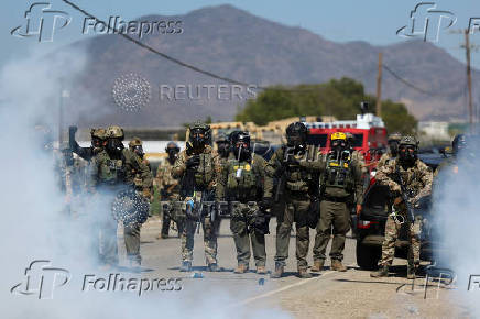U.S. federal agents and immigration officers raid an agricultural facility in Camarillo