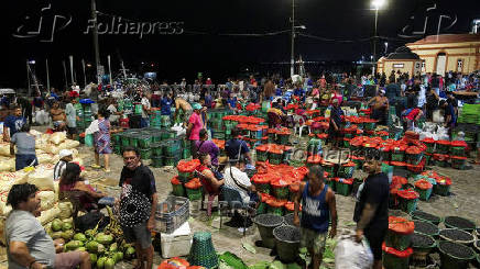 Drone views shows people gathering next to baskets filled with Amazon acai berries at the Ver-o-Peso market