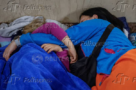 People take shelter inside a metro station during an air raid alert in Kyiv