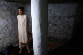 A boy stands in a bunker, build for the safety of their family, to protect them from the cross-border shelling, in Chakothi Village