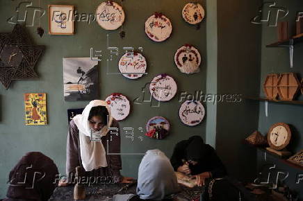 Afghan girl teach Nuristani wood carving skills at a workshop in Kabul