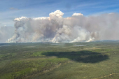 Smoke rises from wildfire LWF090, the Caribou Lake Wildfire in Alberta