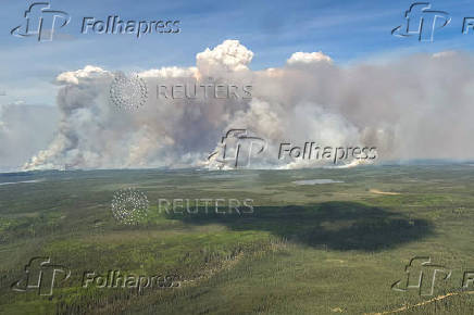 Smoke rises from wildfire LWF090, the Caribou Lake Wildfire in Alberta