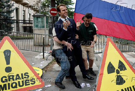 Activists of Greenpeace attend a protest near the Russian Embassy in Paris
