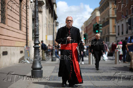 Cardinals walks ahead of the conclave to elect the next pope
