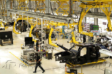 Technicians work on the assembly line for Rolls-Royce Cullinan and Spectre vehicles at Rolls-Royce Motor Cars' manufacturing plant in Goodwood