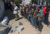 Mourners attend the funeral of Palestinians who were killed, according to medics, in Israeli fire, at Al-Shifa hospital, in Gaza City