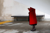 Woman stands under a shelter in a smoking area of the UN headquarters, in New York City