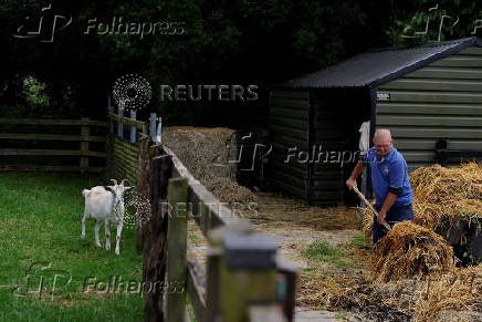 A farmer moves hay, in Lullymore