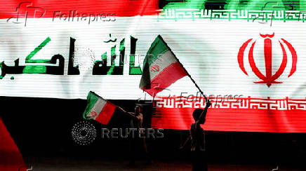 Iraqi people celebrate what they say is Iran's victory, in Baghdad