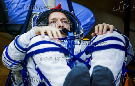 Roscosmos cosmonaut Sergey Ryzhikov looks on during his spacesuit check before the launch at the Baikonur Cosmodrome