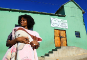 Athenkosi Sobuza stands with her two-months-old baby, Liselihle, outside the Fellowship Baptist Church, where U.S. pastor Josh Sullivan was kidnapped, in Gqeberha