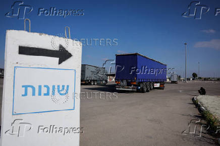 Trucks carrying aid line up at the Kerem Shalom crossing between Israel and Gaza, before going into Gaza, on the Israeli side of the Israel-Gaza border