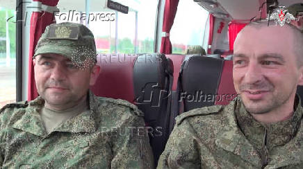 Russian soldiers sit a bus in Belarus after release from Ukraine on the third day of POW exchange