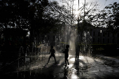 Children play at a fountain in San Salvador