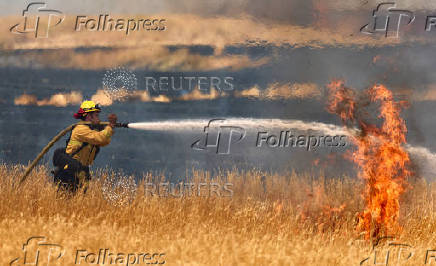 A firefighter battles flames in Woodland California