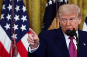 U.S. President Trump signs a resolution at the White House