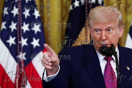 U.S. President Trump signs a resolution at the White House