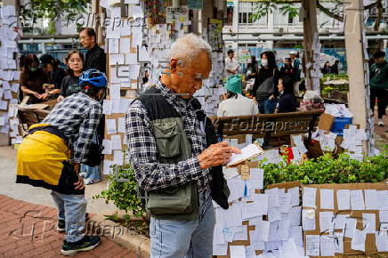 Roadside memorial for victims of the high-rise apartment fire in Hong Kong