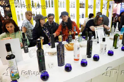 People sample different brands of Spanish olive oil amid the newly imposed U.S. tariffs at the 38th Gourmets Fair in Madrid