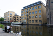 A man fishes during good weather in Regent?s Canal in London