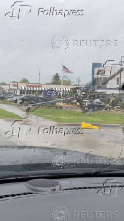 A broken utility pole lies in the aftermath of strong gusts of wind and rain, in Springfield, Missouri