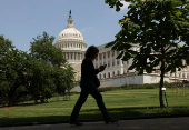 A person walks the grounds of the U.S. Capitol in Washington