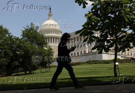 A person walks the grounds of the U.S. Capitol in Washington