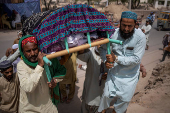 Ansari family carry body of a matriarch to burial place in Multan, Pakistan