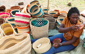 Mercy Kalimi weaves sisal and recycled polythene to make a traditional handwoven basket known as Kiondo at the Mwariro Market in Kariokor district of Nairobi