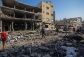 Palestinians inspect destroyed building after Israeli airstrike in Gaza City