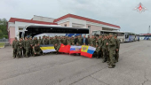 Russian soldiers pose for cameras in Belarus after release from Ukraine on the third day of POW exchange