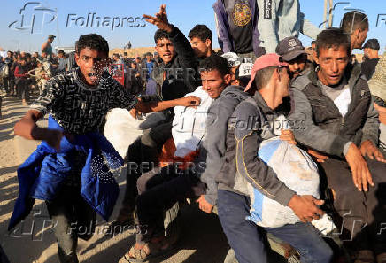 Palestinians receive aid from the U.S.-backed Gaza Humanitarian Foundation, in Khan Younis