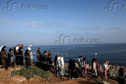 Israeli Muslims pray on the first day of the Muslim holiday of Eid al-Adha by the sea side of the Mediterranean, in Jaffa
