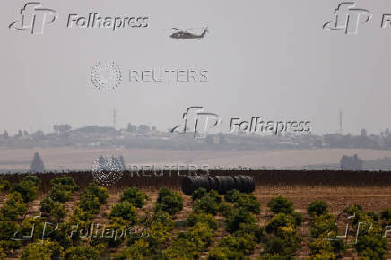 An Israeli evacuation Black Hawk helicopter flies near the Israel-Gaza border
