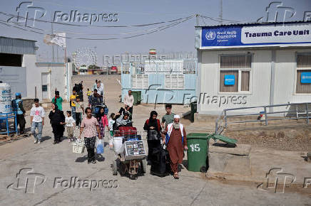 Afghans nationals, who were deported from Iran, arrive at a camp for returning migrants near the Islam Qala border crossing