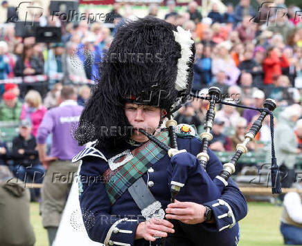 A piper competes in a band competition during the Braemar Royal Highland Gathering at the Princess Royal and Duke of Fife Memorial Park in Braemar, Scotland
