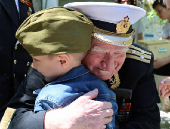World War Two veteran Nikolai Golubtsov receives congratulations on the upcoming Victory Day in Sevastopol